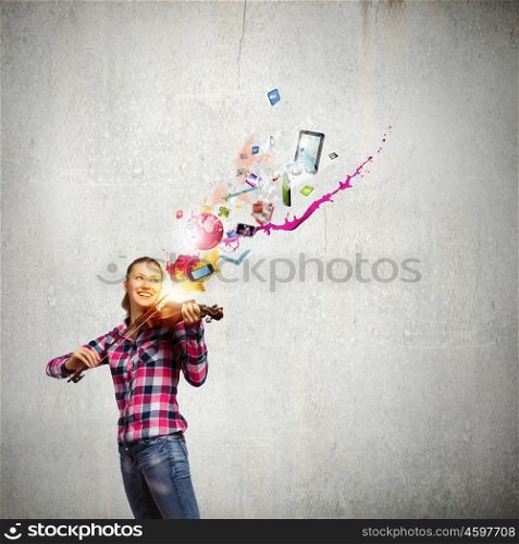 Girl violinist. Young pretty woman in casual playing on violin