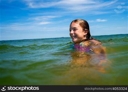 Girl wading in ocean
