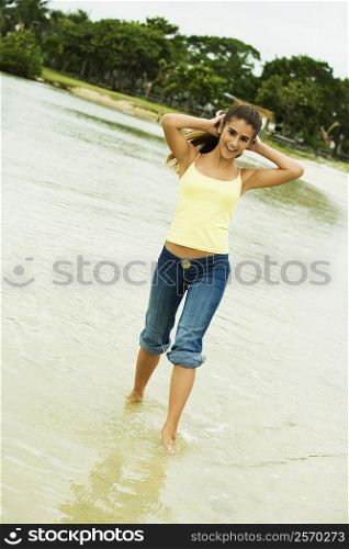 Girl wading in water on the beach