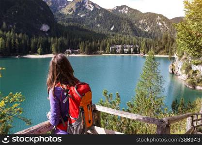 girl walking around the Braies lake, Dolomites Italy