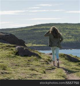 Girl walking at coast, Cape Spear, St. John&rsquo;s, Newfoundland And Labrador, Canada