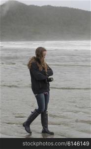 Girl walking on beach, Cox Bay, Pacific Rim National Park Reserve, Tofino, British Columbia, Canada