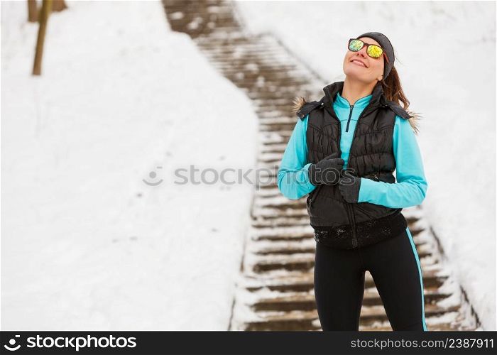 Girl walking on stairs. Taking a walk through the winter park. Health fitness nature fashion concept. . Girl walking on stairs.