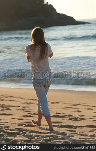 Girl walking on the beach, Sayulita, Nayarit, Mexico