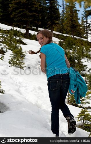 Girl walking up on a snow covered Bald Hills Trails, Jasper National Park, Alberta, Canada