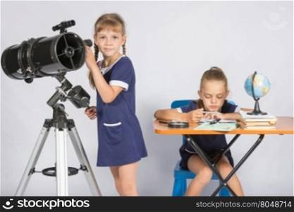 Girl watches in the telescope, the other girl is waiting for the results of observations