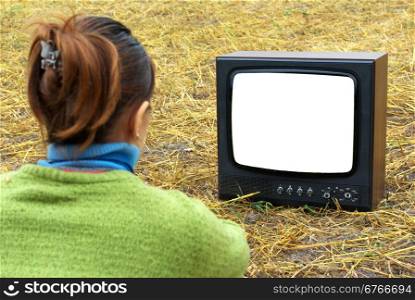 Girl watching TV in meadow. Element of design.