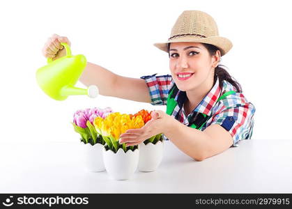 Girl watering plants on white