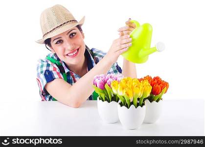 Girl watering plants on white