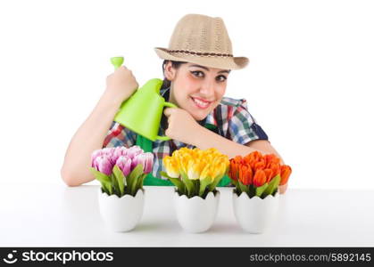 Girl watering plants on white