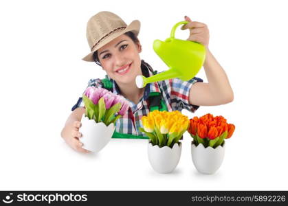 Girl watering plants on white