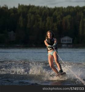 Girl waterskiing in a lake, Lake of The Woods, Ontario, Canada