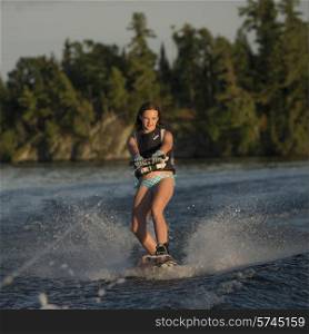 Girl waterskiing in a lake, Lake of The Woods, Ontario, Canada