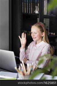 girl waving her colleagues through her web camera