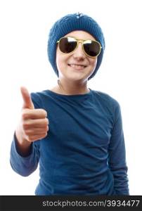 Girl wearing a knitted hat and sunglasses showing thumbs up