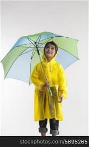 Girl wearing a raincoat and holding an umbrella