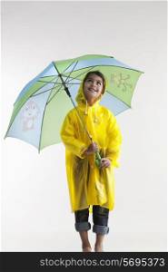Girl wearing a raincoat and holding an umbrella