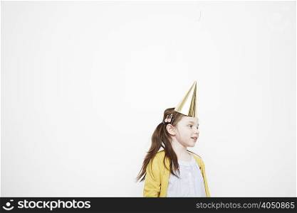 Girl wearing cone party hat