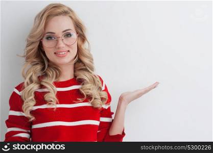 Girl wearing glasses showing copy space. Beautiful girl wearing glasses showing empty copy space