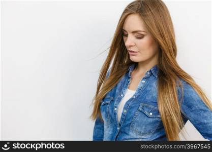 Girl wearing jeans outfit.. Girl wearing jeans outfit. Young fashionable lady. Fashion beauty coiffure lifestyle concept.
