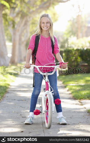 Girl Wearing Rucksack Cycling To School