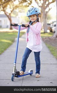 Girl Wearing Safety Helmet Riding Scooter