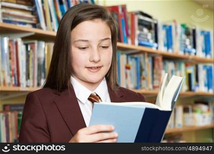 Girl Wearing School Uniform Reading Book In Library