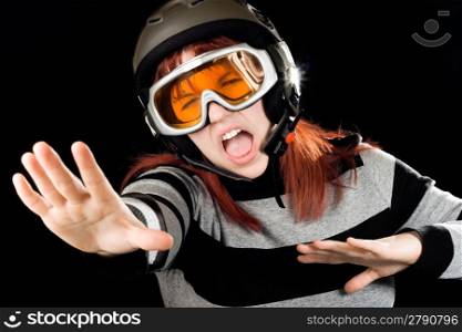 Girl wearing ski helmet and orange google and acting like she was snowboarding. Studio shot.