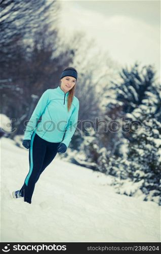 Girl wearing sportswear, trees in background. Winter sports, outdoor fitness, workout, health concept.. Standing girl wearing winter sportswear, trees background