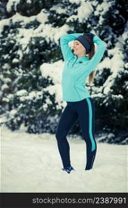 Girl wearing sportswear, trees in background. Winter sports, outdoor fitness, workout, health concept.. Standing girl wearing winter sportswear, trees background