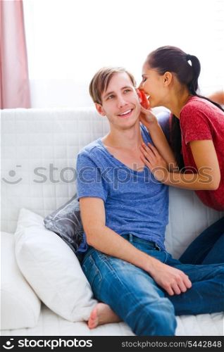Girl whispering something in boyfriends ear&#xA;