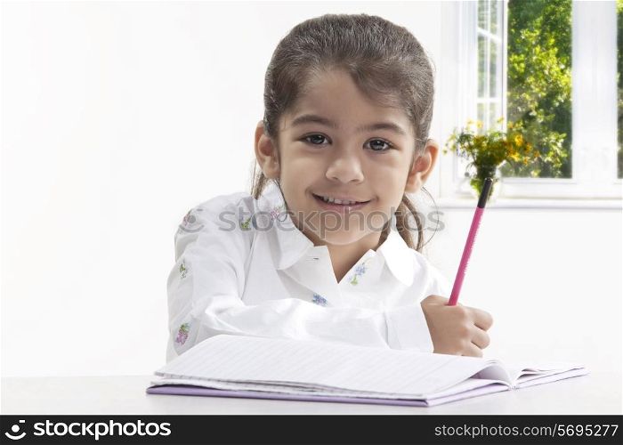 Girl with a book and pencil