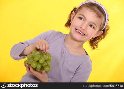 Girl with a bunch of grapes