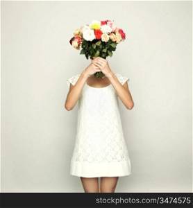 Girl with a head-bouquet of roses. Surreal portrait