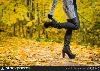 Girl with a high heels on the park, colors of autumn