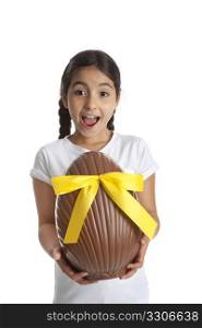 Girl with a large chocolate easter egg on white background