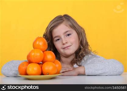 Girl with a pyramid of oranges