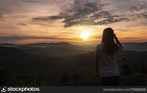 Girl with a sunset on a hilltop