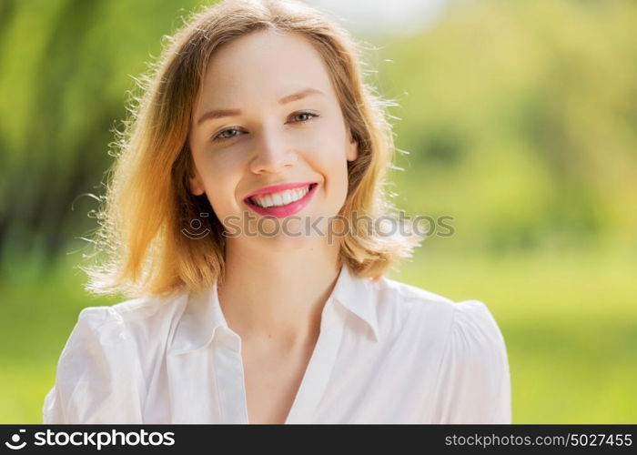 Girl with apple. Young pretty woman in summer park with apple