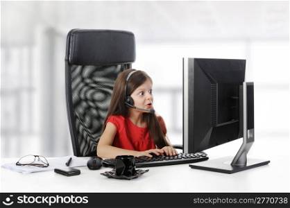 girl with astonishment looks in the computer monitor.