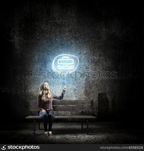 Girl with balloon. Young woman in casual sitting on bench and holding glowing balloon
