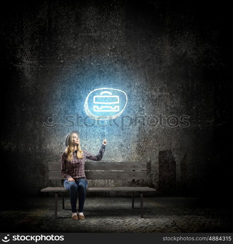 Girl with balloon. Young woman in casual sitting on bench and holding glowing balloon