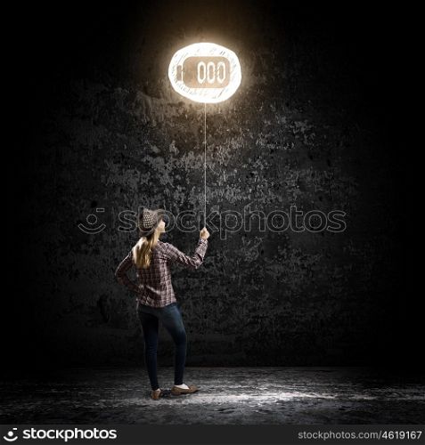 Girl with balloon. Young woman in casual standing with back and holding glowing balloon