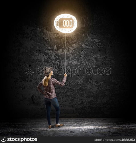 Girl with balloon. Young woman in casual standing with back and holding glowing balloon