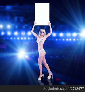 Girl with banner. Attractive girl in swimming suit holding white blank banner above head