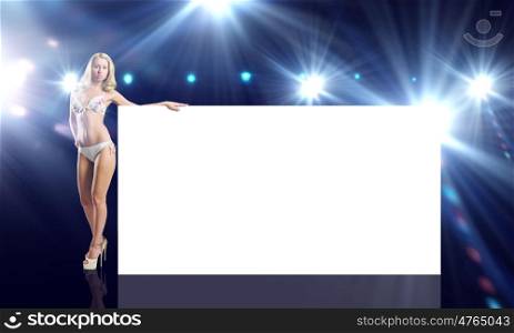 Girl with banner. Attractive girl in swimming suit with white blank banner. Place for text