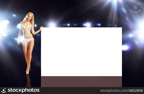 Girl with banner. Attractive girl in swimming suit with white blank banner. Place for text