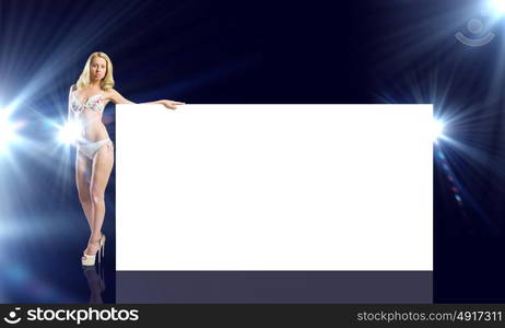 Girl with banner. Attractive girl in swimming suit with white blank banner. Place for text