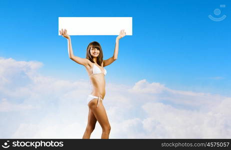 Girl with banner. Young pretty girl in bikini holding blank banner