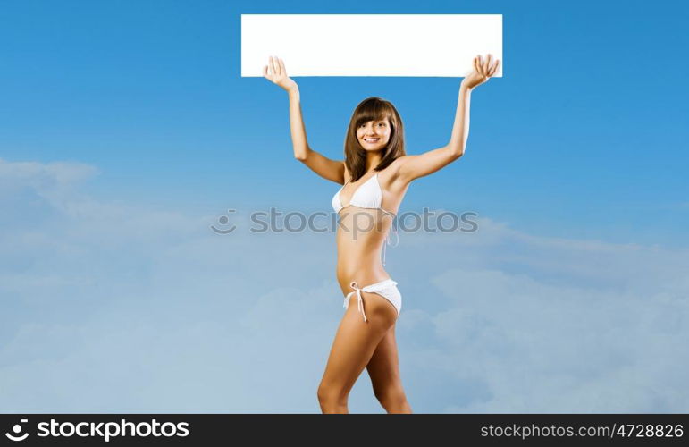 Girl with banner. Young pretty girl in bikini holding blank banner